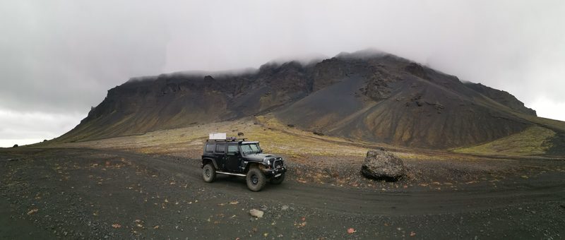 Vehicle in front of mountain